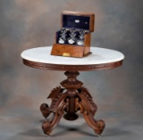An elaborate early Victorian Walnut Lamp / Parlor Table, circa 1880s, attributed to famous cabinet m