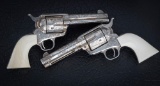 Beautifully engraved matched pair of Second Generation Colt SAA Revolvers, engraved by master engrav