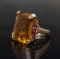 A 14 Kt. Yellow gold, Emerald cut citrine Ring with a 21 x 16 citrine in the center flanked by three