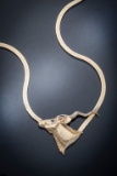 A ladies Herringbone Chain with a gold and diamond Pendant.  The neckpiece weighs 70.7 grams.  The P