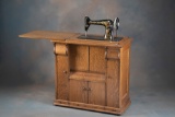 Outstanding antique, Singer Sewing Machine in quality quarter sawn oak cabinet, unique push button,