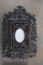 Black Forest Wall Hanging Cabinet with heavy carved grapes, vines and leaves, oval mirrored front, s