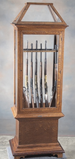 Most unusual, heavy quarter sawn oak, two piece, Gun Cabinet with bronze label on front "JW Winchest