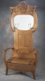 Fancy antique oak, lift seat Hall Tree with beveled mirror and coat & hat hooks, circa 1900-1910 mea
