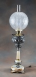 Very ornate Victorian Table Lamp, circa 1880s, with claw foot brass base, ornate silver font and fit