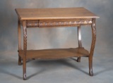 Antique quarter sawn oak Library Table with carved hide away drawer and suspended stretcher, circa 1
