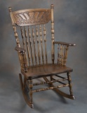 Antique oak, press back Arm Rocker, with spindle back and shaped seat, good finish and condition.
