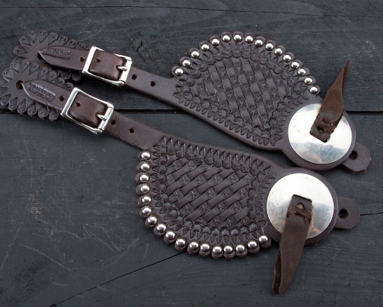 A pair of unused spotted two piece Spur Straps, basket weave pattern with silver conchos by the late