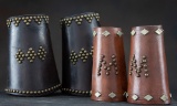 This  will include the following two items:  (1) A pair of early spotted leather Roping Cuffs with b