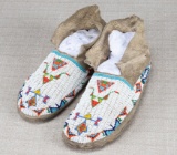 Pair of early sinew sewn Plains Moccasins.  NOTE: Beaded Long Horn design on vamp, shows no bead los