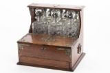 Antique oak case, three bottle Tantalus with ground stopper tops, in original finish, circa 1910, wi