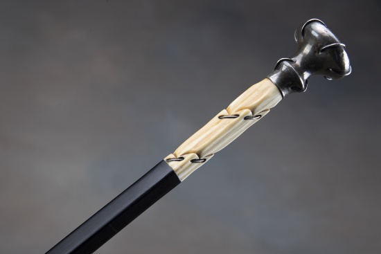 Unusual vintage Cane with ebony square shaft and carved ivory handle with "Sterling" marked cap.  To