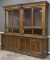 Antique oak country store, two piece, step front Wall Cabinet with wooden and glass sliding doors, c