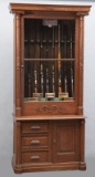 A unique antique, two piece, quarter sawn oak, single door Gun Cabinet, circa 1900-1910, original fi