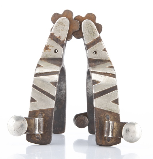 Pair of "Crockett" marked single mounted Spurs with silver overlay, done in the Patty Ryan pattern,