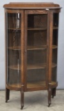 Antique curved glass, oak Curio Cabinet, circa 1910, complete with three matching wooden shelves, in