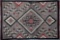 An original antique Navajo Rug, circa 1915, with attached photograph label marked 