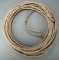 Hand braided, rawhide Riata, approximately 60 ft. L, with rawhide hondo.