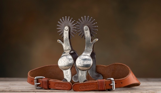 A pair of "Crockett-Adamson" marked single mounted, full engraved silver overlay Spurs in the famous