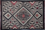 An original antique Navajo Rug, circa 1915, with attached photograph label marked 