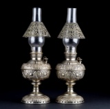 A pair of antique, heavily embossed Oil Lamps in original nickel over brass finish (shows some light