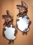 Unique pair of Black Forrest style, beveled glass hanging mirrors. Mirrors are inset in beautifully