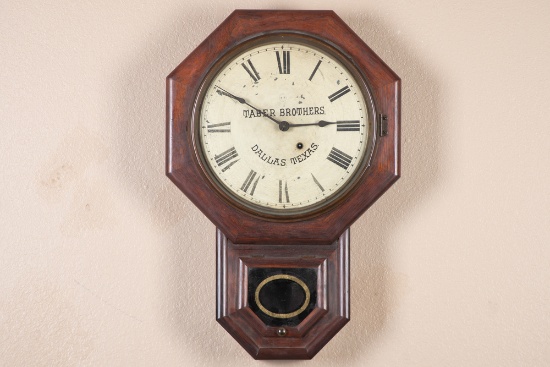 Vintage short drop school house Regulator Clock with advertising for Taber Brothers, Dallas, Texas.
