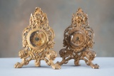 A pair of antique cast iron easel Clocks with embossed figures, one is marked 