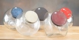 This lot consists of  five vintage glass Biscuit Jars with lids, four are made to sit up straight or