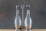 Silver and crystal Tantalus, bottles have ground stoppers and measures 11