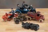 This lot consists of a collection of five cast iron toys. (1) Orange motorcylcle with rider titled 