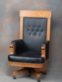 Massive antique, quarter sawn oak swivel Desk Chair, circa 1910, covered in black leather with brass