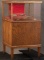 Vintage floor model oak & glass Display Cabinet on footed base with rear loading door and double doo