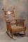 Ornate quarter sawn oak antique Arm Rocker with cannon ball posts and 11 turned spindles on each sid