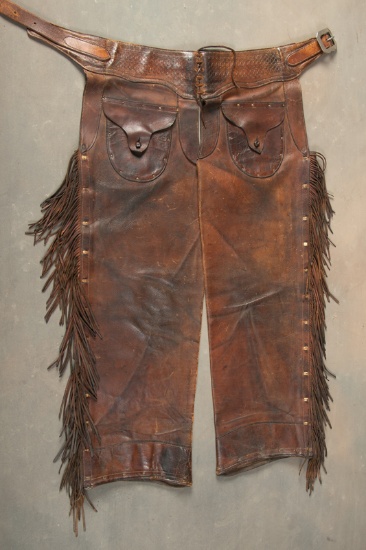 Pair of vintage Stove Pipe Chaps with heavy fringed border, outside pockets with leather buttons, ma