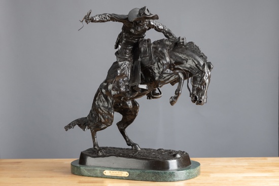 Bronze Western Sculpture with brass label on front titled "The Bronc Buster, Frederic Remington", me
