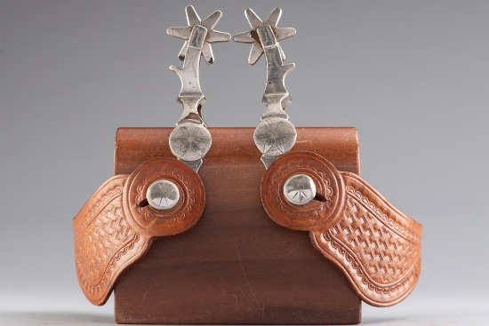 Pair of "McChesney" marked single mounted Spurs (Nocona Period), with raised engraved conchos on hee