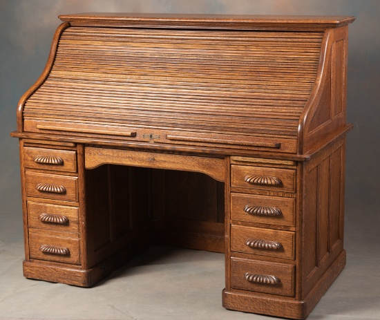 Fantastic antique 60" S-curved Roll Top Desk, circa 1900-1910, with raised panels and carved pulls.