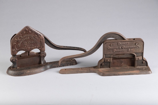 Two antique cast iron Tobacco Cutters: One is advertising "Dermot Groceries and Commission Co., Derm
