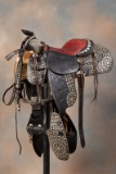 Three-Piece highly tooled and spotted Saddle Ensemble covered in silver spots. Saddle is attributed
