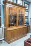 Antique two-piece quarter sawn oak, double door, wall model Gun Cabinet, circa 1900, with fancy crow