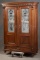 Antique double door walnut Bookcase, circa 1890s, with full length etched glass panels in top, carve