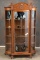 Antique oak curved glass China Cabinet, circa 1910, with rope twist column front, claw feet and carv