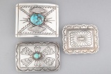 Three silver Belt Buckles in traditional Navajo Patterns, two with turquoise stones. The largest Bel