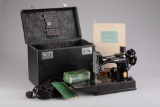 Cased Singer Feather-Lite Sewing Machine, original black lacquer with gold lettering. In original ca