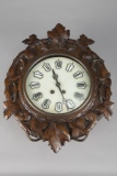 Antique Black Forrest oval shaped Wall Clock with marble dial and porcelain numbers, both time and s