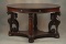 Antique Mahogany Oval Library Table, circa 1900-1910, with fully carved winged griffins supporting t