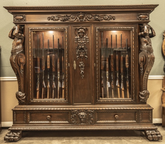 Fantastic and monumental antique mahogany double door Gun Cabinet, elaborately carved with 50" full