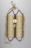 Pipe stone beaded and fringed Breast Plate, showing wear and age.