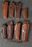Collection of eight Holsters made by Lawrence Co., Portland, Oregon. All tooled in a basket weave pa